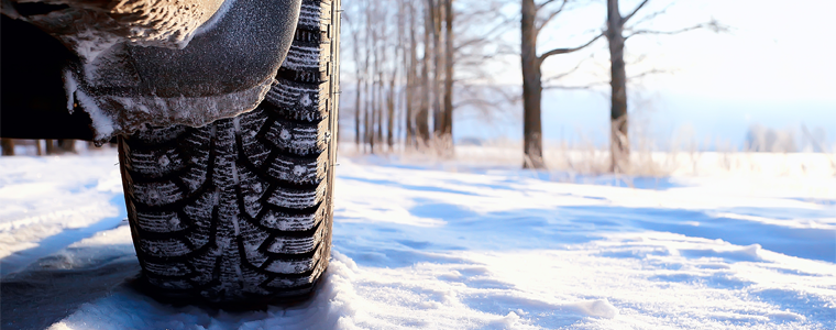 car tire and tracks in snow