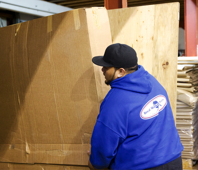 worker carrying box in warehouse