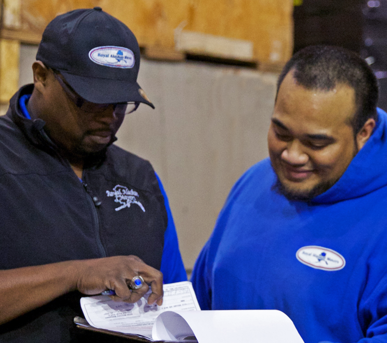 looking over paperwork in warehouse